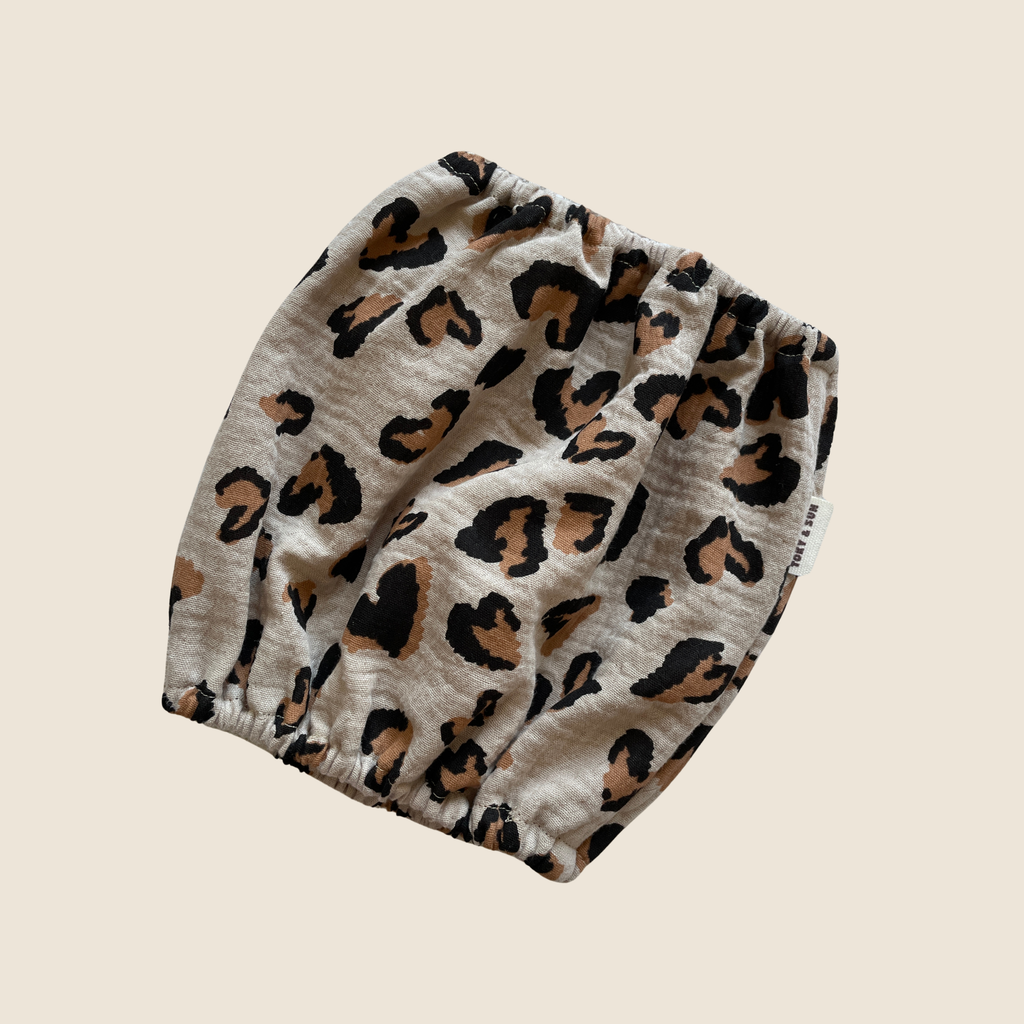 Snood Olé Léo pour chien en coton imprimé léopard beige, conçu pour maintenir les longues oreilles propres et protégées au quotidien.